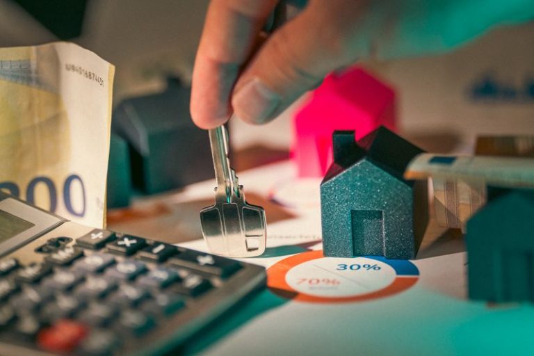 miniature houses, a key, cash, and a calculator